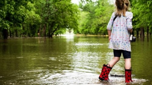 Girl in Flooded Street - Hurricane coverage for floods - Think Safe Insurance   813-425-1626